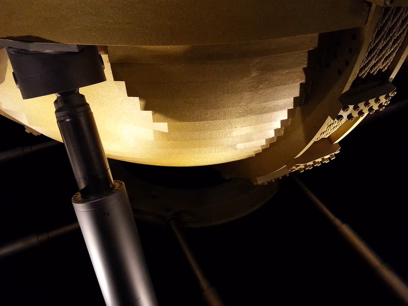 A high-tech mechanical component, likely part of a larger machine or device, with a close-up view highlighting its intricate details and texture.